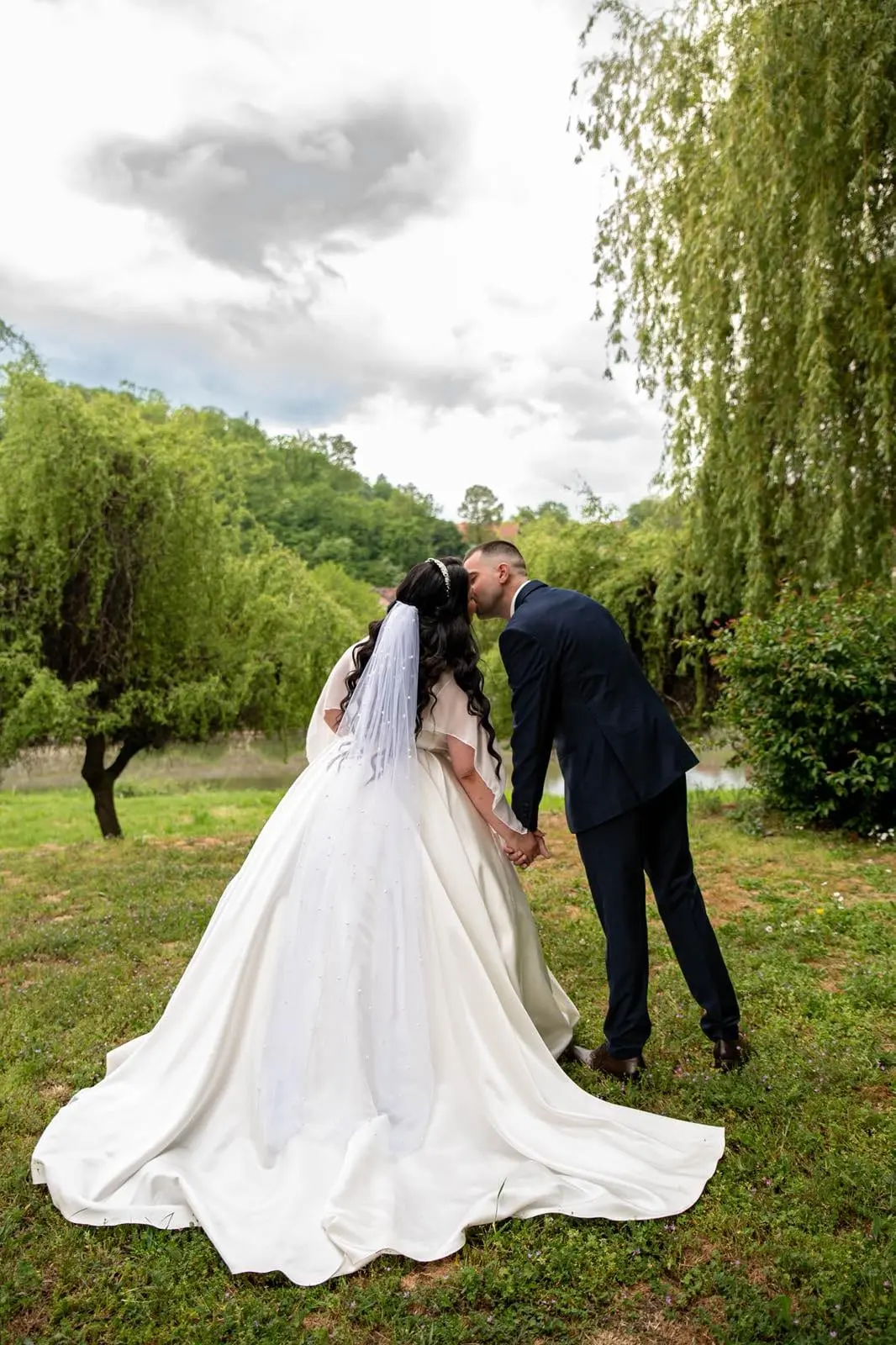 Mlada i mladoženja pod vrbom, venčanica kroja princeza sa velom i šlepom